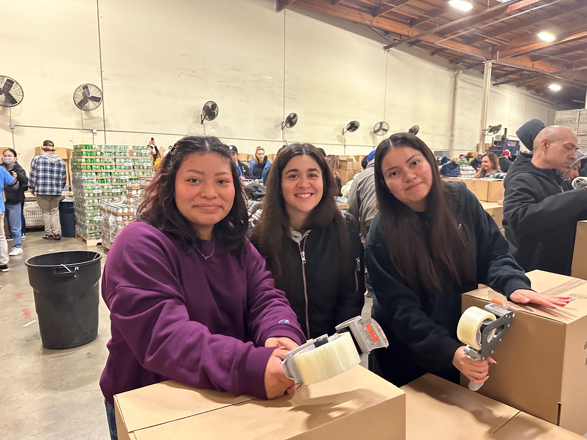 SAC ULink Students packacking food boxes at the OC Food Bank volunteer event.